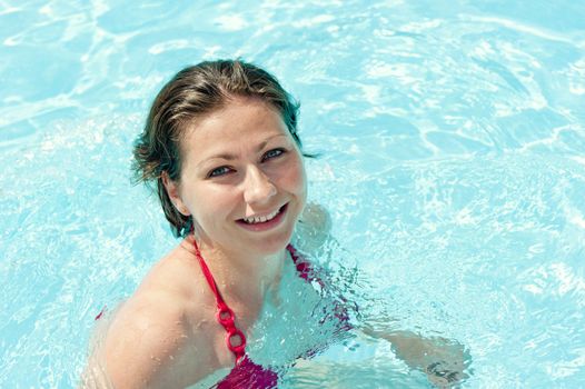 fun playful young girl bathes in pool