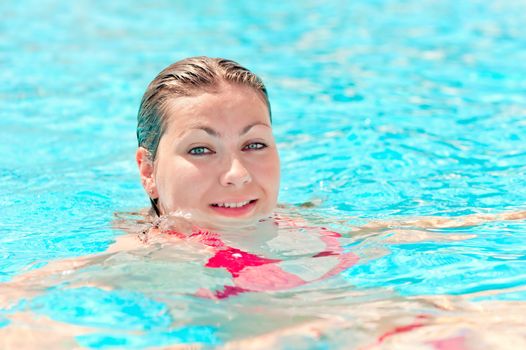 portrait of a smiling young girl in the pool