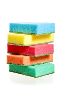 a pile of sponges for washing dishes of different colors on a white