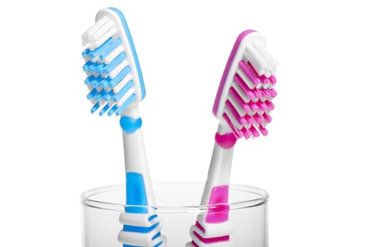 Head Toothbrush standing in a glass on a white background