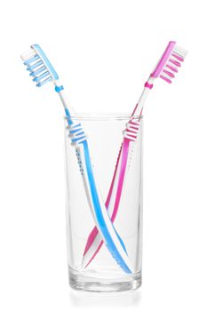 quarreled toothbrushes in a glass on a white background