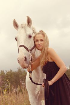 beautiful young woman with a  horse in the forest