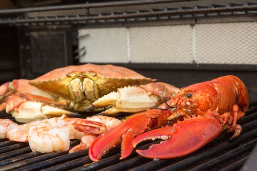 Barbecuing red Lobster, dungenees crab and jumbo Shrimps