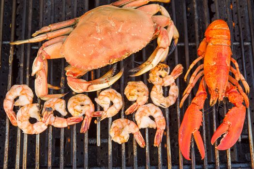 Barbecuing red Lobster, dungenees crab and jumbo Shrimps