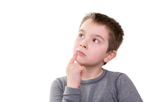 Young boy pushing the limits of his thought process, isolated on white