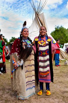 Whitesburg, GA - Sept. 29: Native American Indian woman in front of Tipi at the McIntosh Fall Festival, Sept. 29 2013 in Whitesburg, GA.