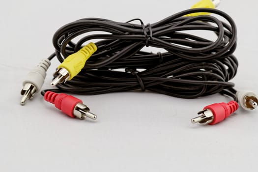 three audio (left - right) - video RCA cable and plug (red, white, yellow) on white background