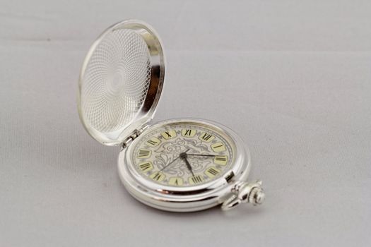 Part of a antique mechanical pocket watch on white background