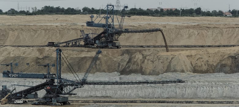 Coal mining in an open pit with huge industrial machine