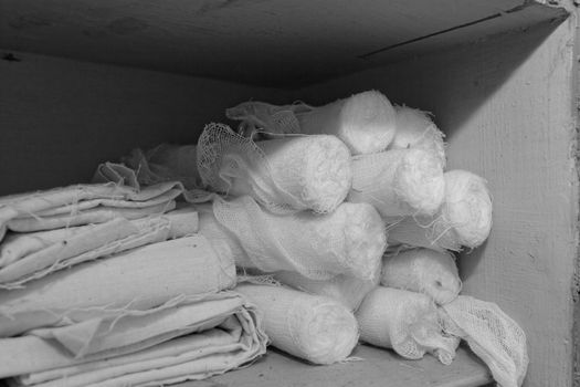 white sterile medical dressings in the old war cabinet bw color