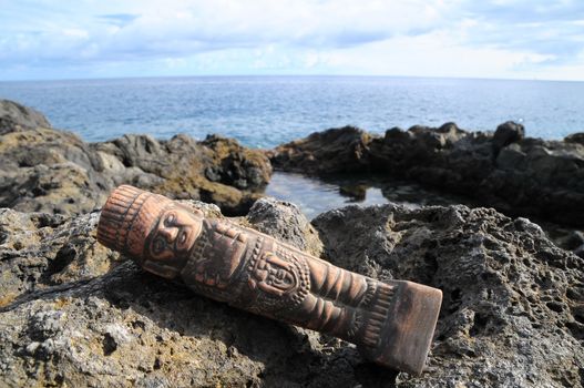 Ancient Maya Statue on the Rocks near the Ocean