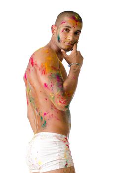 Attractive young man shirtless, skin painted all over with bright Honi colors, profile view, looking in camera