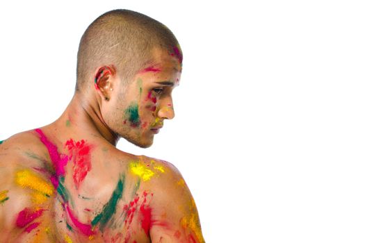 Handsome young man with skin all painted with colors, profile view from the back