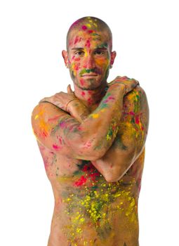 Attractive young man shirtless, skin painted all over with bright colors, isolated on white