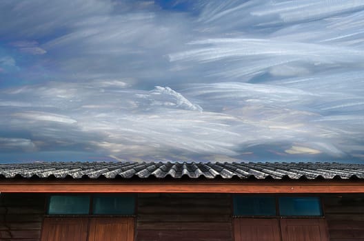 The Moving of Freezing Cloud in Blue Sky Over Roof of Wooden House.
