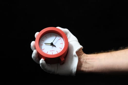 Clock And an Hand on a Black Background