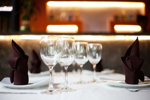 Restaurant table with two menu sets and a bar in the background