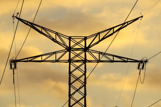 Power Electric Tower on a Cloudy Sky at Sunset