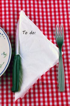 To do list on a white napkin, in a table