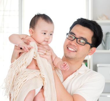 Asian father and six months old baby girl