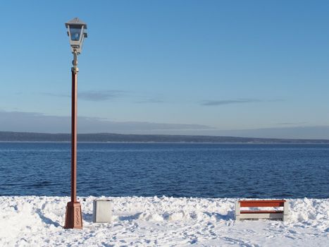 bench and lantern on the quay in winter