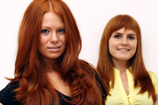 Two young beautiful redhead women