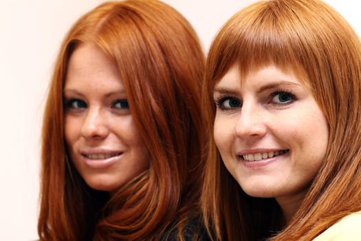 Two young beautiful redhead women