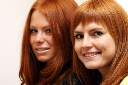 Two young beautiful redhead women