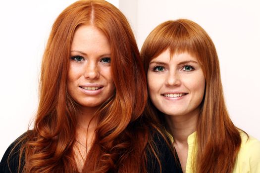 Two young beautiful redhead women