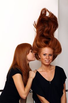 Two young beautiful redhead women