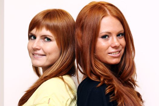 Two young beautiful redhead women