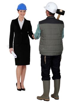Builder and businesswoman shaking hands