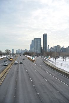 Chicago highway with snowy weather with copyspace on the road and grouped cars.
