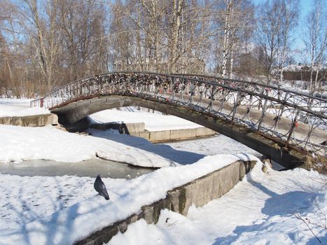 The bridge through the river in the winter 