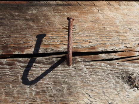 bent nail into a wooden wall