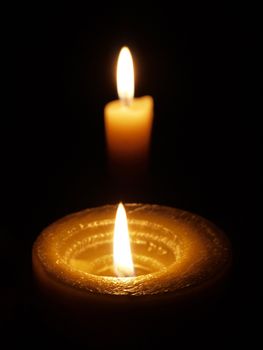 Candle on black background