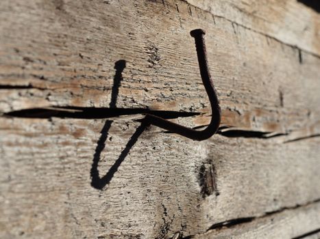 bent nail into a wooden wall