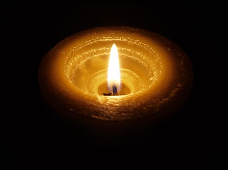 Candle on black background
