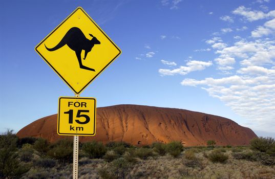 Road sign near Ayers Rock in the Northern Territory of Australia. It is the largest monolith in the world, at 348 m high and about 9 km in circumference. Aboriginal name Uluru. It is a UNESCO World Heritage Site.