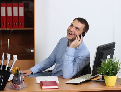 Smiling man talking on mobile phone