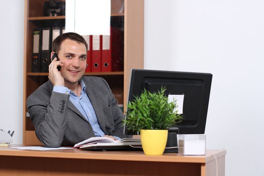 Smiling man talking on mobile phone