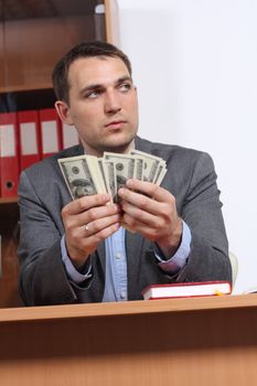 A young man with dollars in their hands