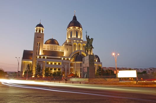 Orthodox cathedral and night trafiic in Romania