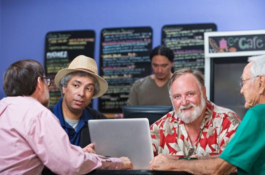 Cheerful man with diverse friends in cafe