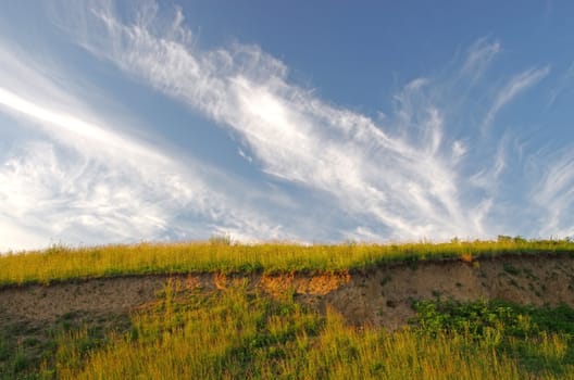 Cliff wall: Clay brown soil and green grass