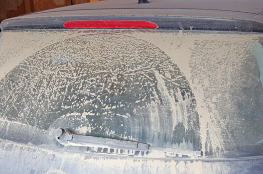 A lot of dust on a black car