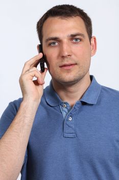 young man on his mobile phone against a white background