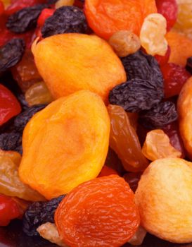 Heap of Delicious Sweet Dried Fruits with Apricot, Cherry, Black and White Raisins closeup
