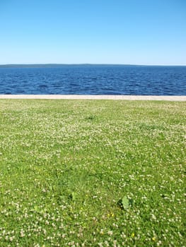 Lake, the sky and grass. Petrozavodsk, Russia, Karelia               