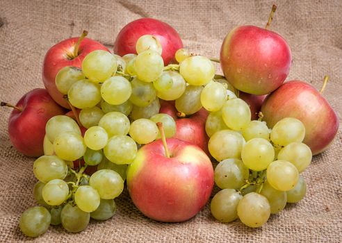 Still life with autumn fruits on burlap background